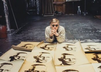 Imagem de Andy Warhol diante de suas serigrafias. Imagem: Autoral Filmes / Divulgação.